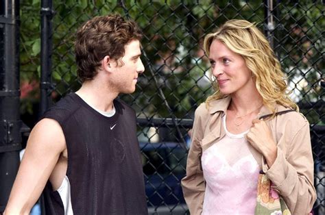 Uma Thurman in the movie Prime. She's wearing a pink shirt and tan jacket and looking at a young guy with dark hair