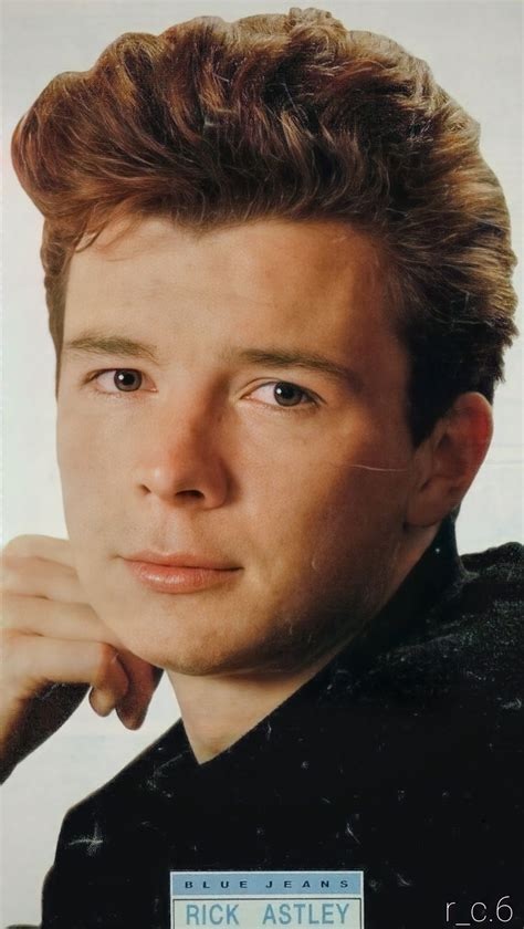 Photo of a young Rick Astley, the British singer. He's wearing black and staring into the camera.
