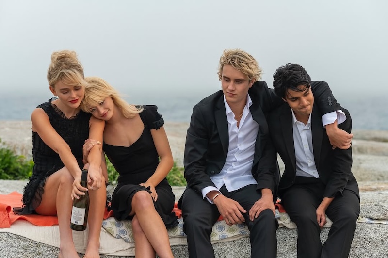 Four dressed up teens on a wall