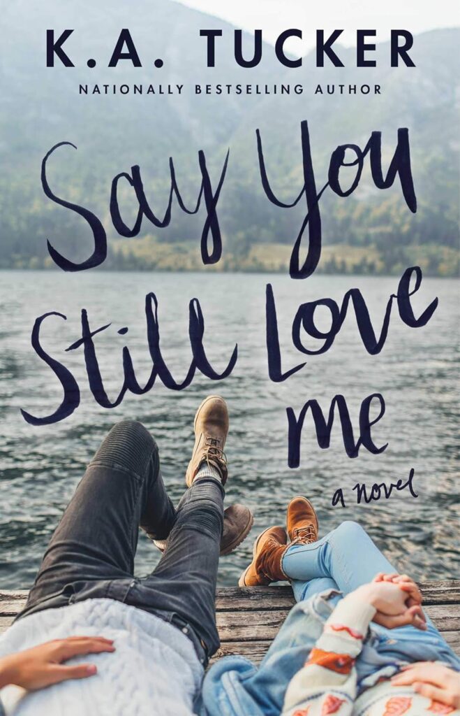 Cover of Say You Still Love Me which shows the legs of a couple on a dock over a lake