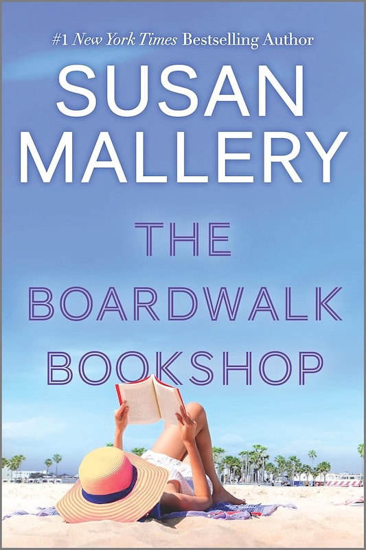 Cover of The Boardwalk Bookshop which shows a woman in a straw hat lying on the beach reading