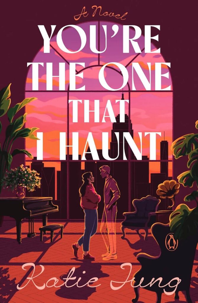 Cover of You're the One That I Haunt, which shows a view of a NYC sunset from inside an apartment.